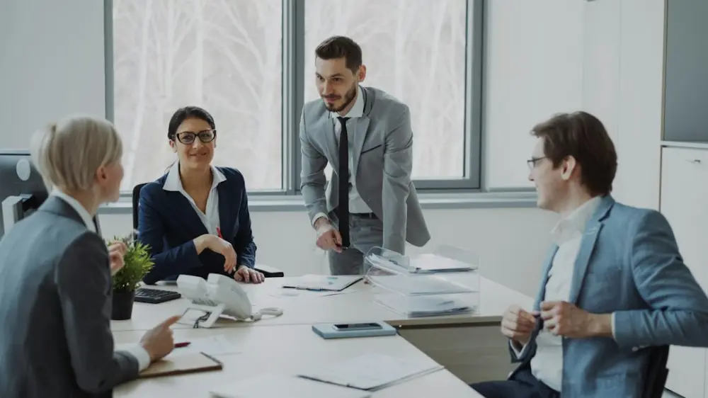 Business professionals collaborating around a conference table, illustrating management training and certification